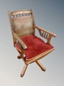 An Edwardian beech swivel desk chair