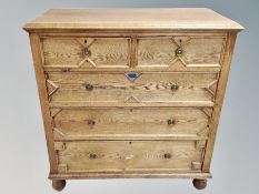 A 17th century style oak straight front chest of five drawers on bun feet,