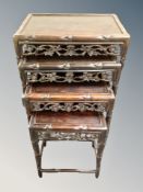 A Chinese carved hardwood nest of four tables,