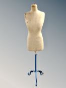 An early 20th century mannequin stand on wrought metal support