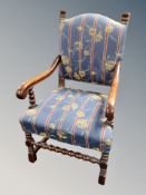 A continental oak armchair in striped upholstery