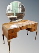 A burr walnut mirror backed dressing table on cabriole legs,