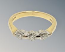 An 18ct gold three stone diamond ring, size K1/2 CONDITION REPORT: 3.
