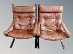 A pair of Danish buttoned tan leather armchairs