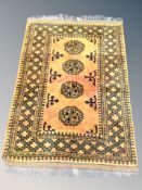 An Afghan Bokhara rug on gold ground,