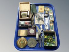 A tray of collectables, glass marbles, Festival of Britain coin, guitar tuner, brass nut crackers,