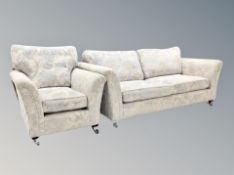 A contemporary four seater settee in cream and light blue floral upholstery,