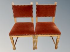A pair of oak framed dining chairs in buttoned dralon