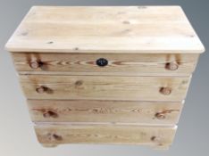 An early 20th century pine low chest of four drawers,