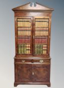 A good quality burr elm bookcase in the George III style fitted with double door cupboard and
