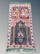 An Eastern prayer rug 107 cm x 51 cm