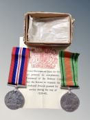 A brass cased Mk III compass together with a WWII War Medal and Defence Medal in box of issue