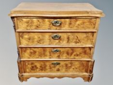 A 19th century Danish figured walnut serpentine fronted four drawer chest,