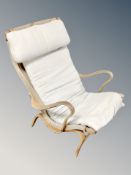 A Scandinavian beech framed armchair with canvas seat