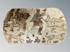 A 1970's studio pottery wall plaque depicting a falconer on horseback with hounds,