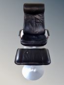 A Danish black stitched leather armchair on chrome base with matching footstool
