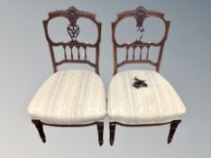 A pair of mahogany salon chairs in striped upholstery
