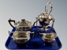 A silver plated spirit kettle on naturalistic stand,