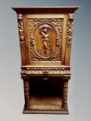 A 19th century Danish heavily carved oak single door cabinet on stand fitted a drawer,