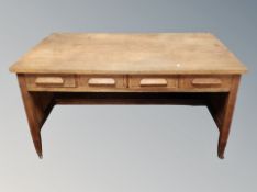 A 1930's oak four drawer writing desk,