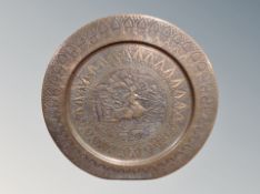 A large Indian embossed copper charger,