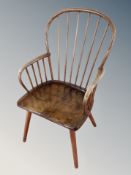 An early 20th century beech spindle backed kitchen armchair