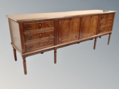 A Danish mahogany low sideboard fitted with cupboards and drawers,