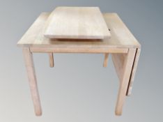 A Danish light oak extending drop leaf dining table