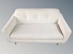 A late 20th century two seater settee in light grey fabric,