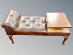 A teak telephone seat in studded brown leather,