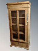 A 19th century pine single door bookcase with shelved interior,