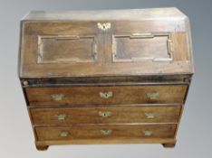 A 19th century oak fall fronted writing bureau with heavy cast iron handles,