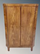 A 19th century walnut double door corner cabinet with shelved interior
