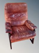 A Danish buttoned and stitched brown leather armchair
