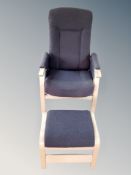 A late 20th century Danish beech framed armchair with matching footstool in dark grey upholstery