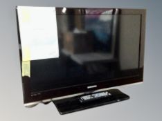 A Samsung 32 inch LCD TV with lead and remote