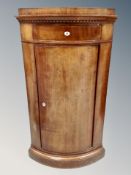 A 19th century Scandinavian mahogany bow front corner cabinet