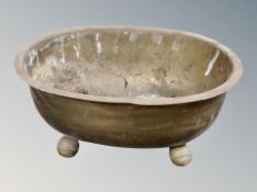 A 19th century brass oval jardiniere on spherical feet,