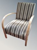 A Fritz Hansen oak framed armchair in striped upholstery
