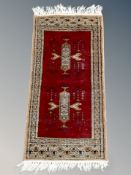 A small Iranian hearth rug 66 cm x 32 cm