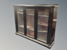 A 19th century ebonised three door bookcase with shelved interior,