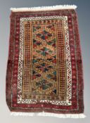 An Afghan/Caucasian rug on red ground,