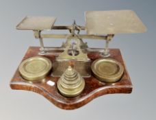 A large set of 19th century brass and oak postal scales with weights,