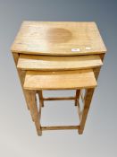 A teak nest of three tables,