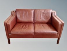 A late 20th century Stouby brown/terracotta leather two seater settee,