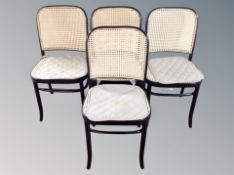 A set of four ebonised cane dining chairs and one further similar (5)