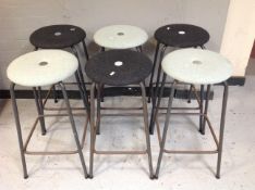 A set of six metal stools in grey upholstery