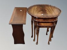 A mahogany nest of three tables and a magazine rack