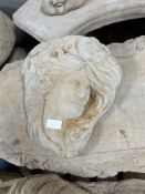 A concrete wall pocket in the form of a maiden,