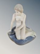 A Royal Copenhagen figure of a Mermaid seated on a rock,